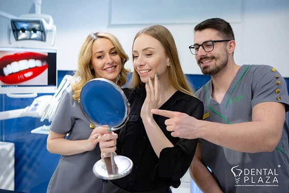 devojka se ogleda u ogledalu u stomatoloskoj ordinaciji