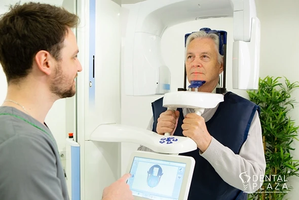 An elderly man having a CT scan of the jaw.